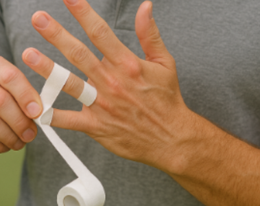 Golfer putting white elastic tape on fingers