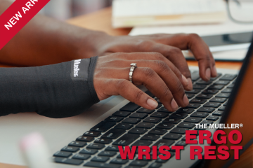 Hands typing on a laptop keyboard.